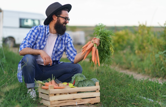 The man with natural carrot in garden