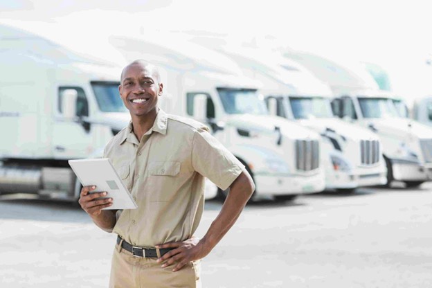 Man smiling in front of truck, CA